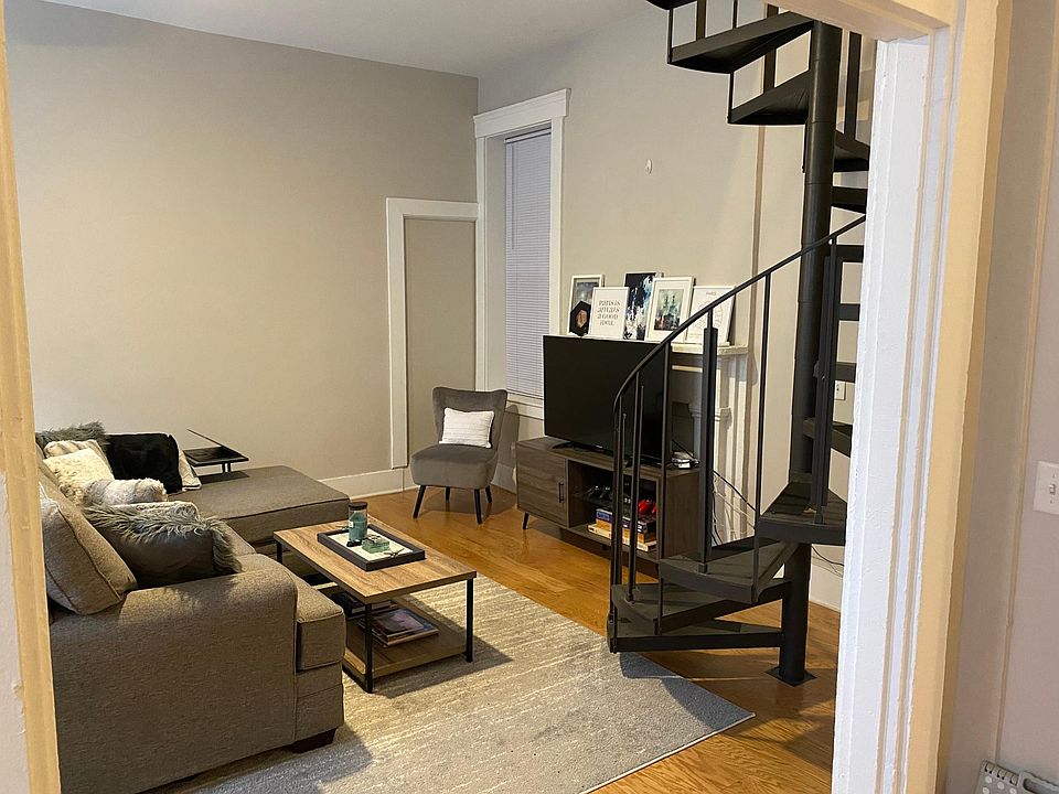 Living room has ample space for 1 or 2 couches. High ceilings and lots of natural light.