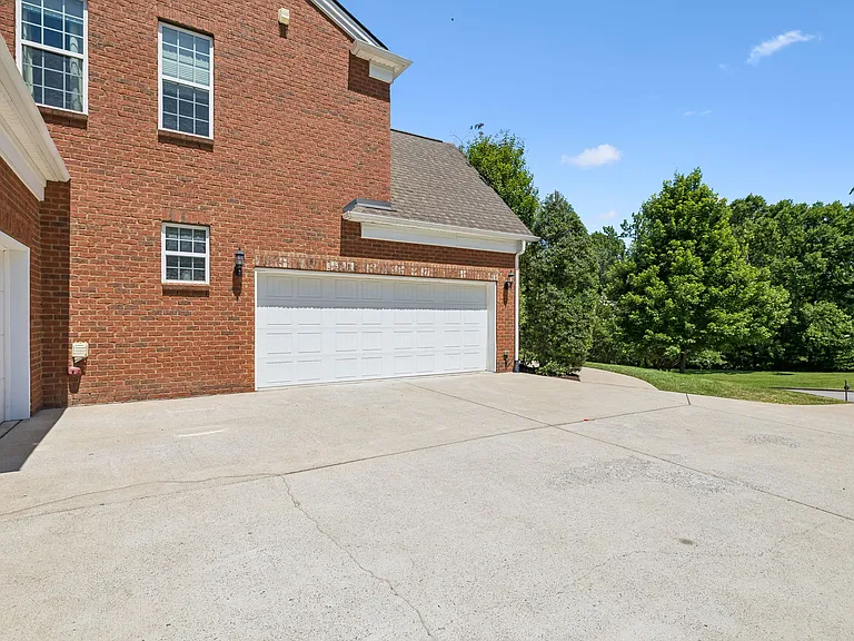 A true 3 car side garage: one side with 2 bays & the other with a single bay!
