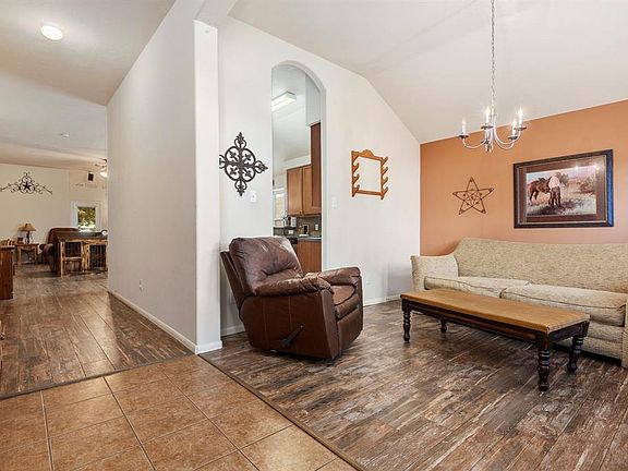 The common areas have tile and durable wood look tile. The home has a great formal dining space at the front and a bedroom that would be a perfect office or playroom.