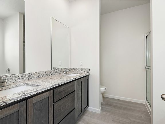 The master bathroom is spacious and has a large vanity