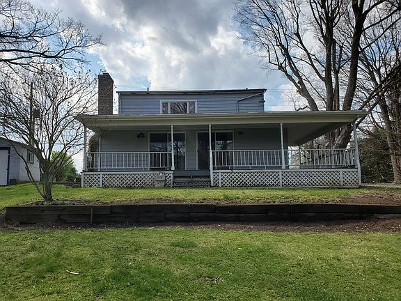 Rear Exterior with full back porch overlooking nature and creek!
