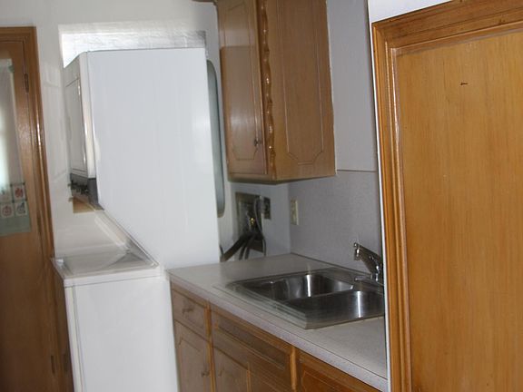 KItchen with deep, double, stainless sink and counter, both sides of Kitchen .