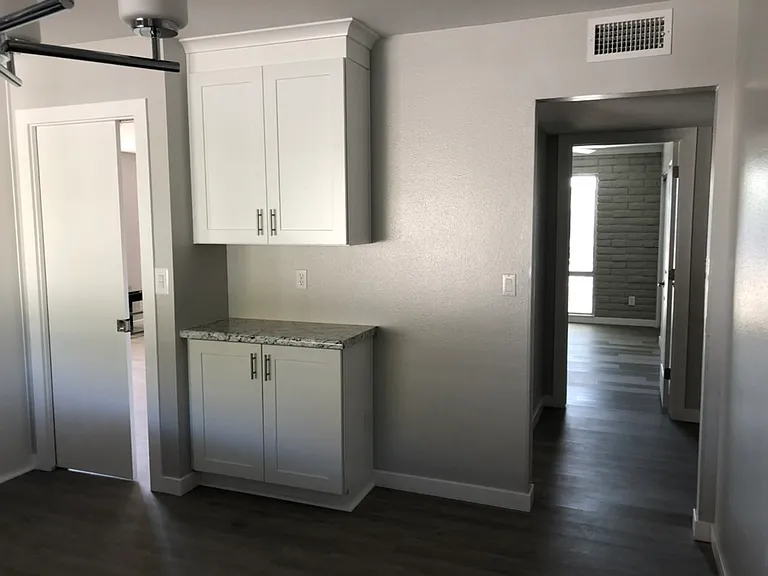 Otherside of Kitchen in the Dining area, left pocket door to livingroom, right doorway to hallway and bedrooms