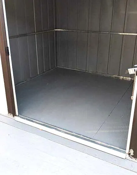 Private backyard storage shed provides extra space for tools, equipment, or seasonal items.