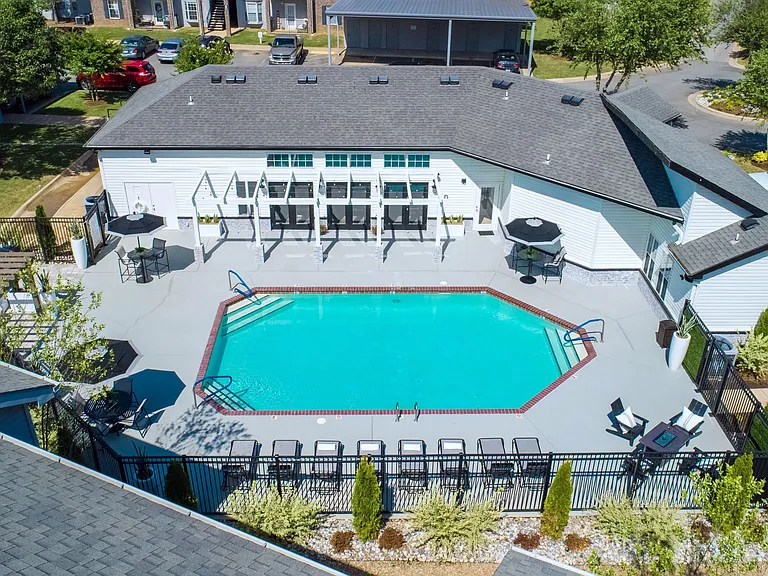 Embrace poolside bliss with sun loungers and stunning landscaping, providing a serene setting for relaxation by the clubhouse.