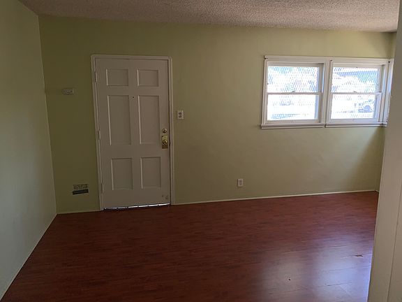 living room, wood floors through the apartment. tile in kitchen and bath