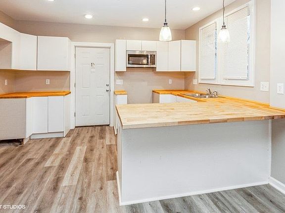 Kitchen with plenty of cabinetry and breakfast bar