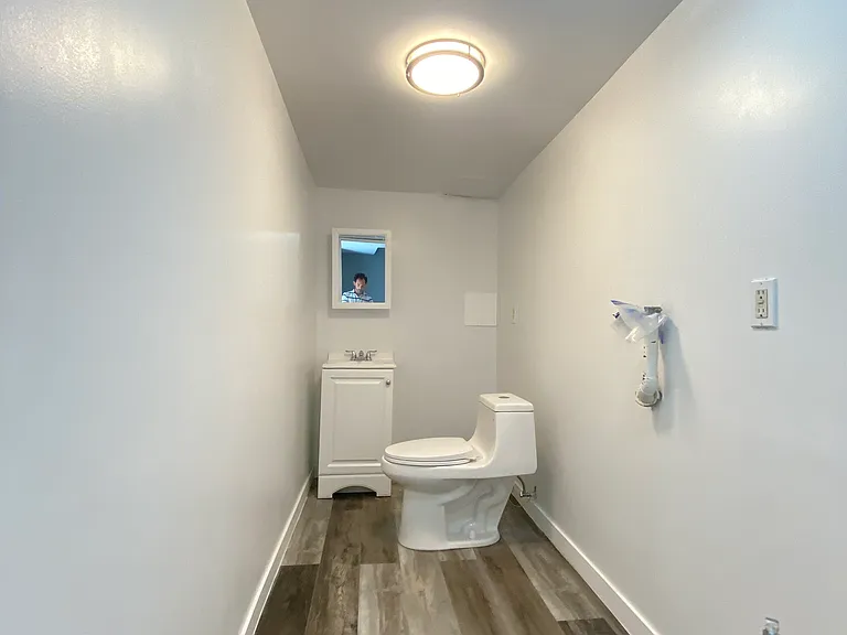 Downstairs 1/2 bathroom + Laundry .