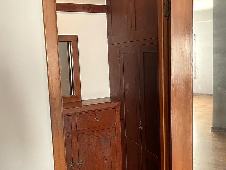 The bathroom and dressing area are separated by a door. Inside the dressing area are classic built ins as well as a spacious closet!