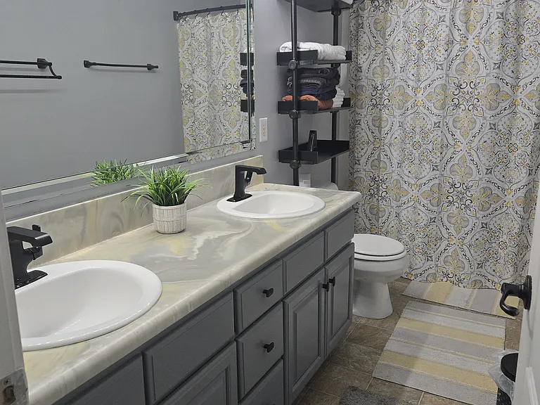 Upstairs full bath: Jack and Jill sink; towel tower/shelving unit