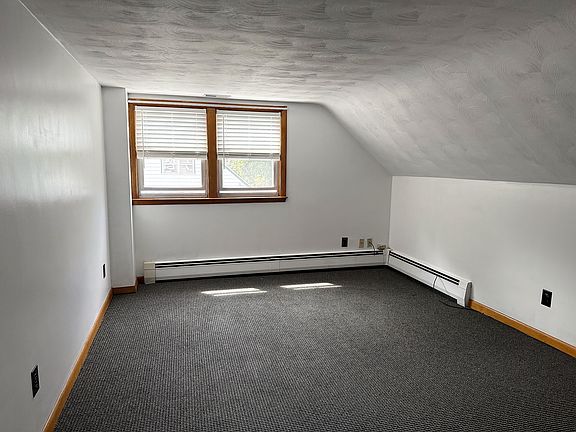 Living room under sloped ceilings, comfy in New England winter nights.