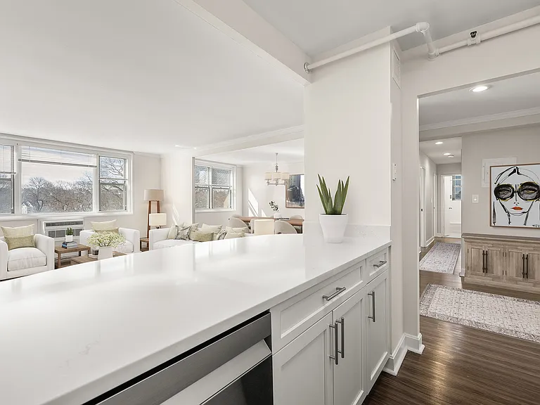 Bright and inviting living space with elegant decor, large windows, and modern quartz kitchen counter detail at Parkside Place, apartments in Cambridge, MA