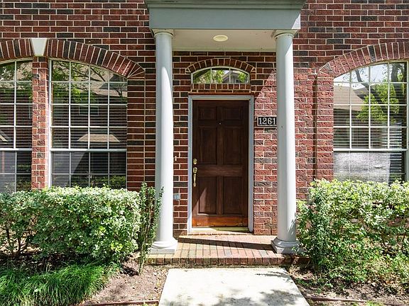 A covered entry leads to the solid wood front door.
