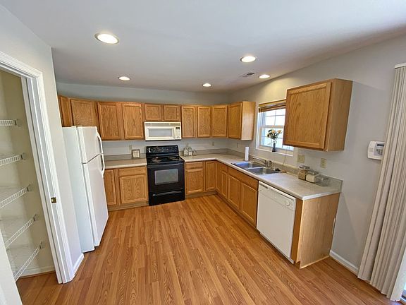 Eat-in Kitchen with Pantry Closet, Range, Frig, Microwave & Dishwasher, Lots of Natural Light, Rear Patio with Sliding Door access to Kitchen