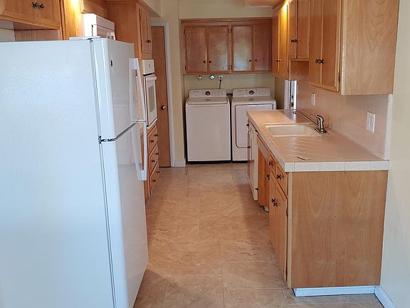 Washer and dryer with laundry area