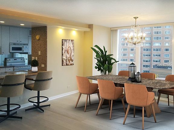 Dining room with elegant chandelier, combined with living room.