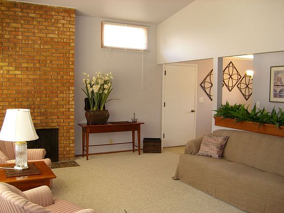 Bright vaulted living room with Chicago brick fireplace