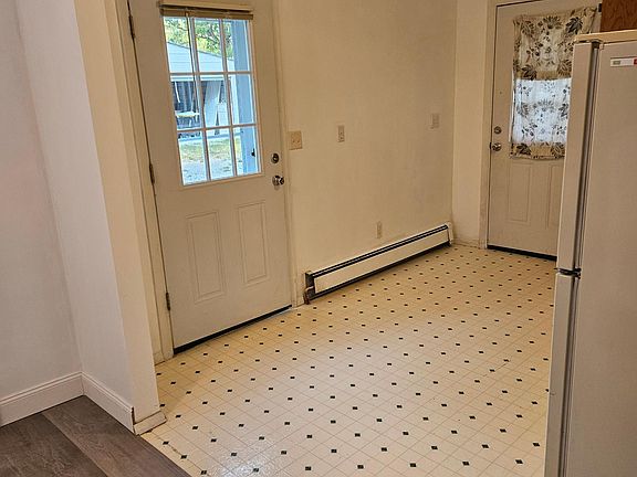 Inside the main entrance looking back. You see the where the linoleum and new vinal flooring meet. This is the separation of the living room and kitchen