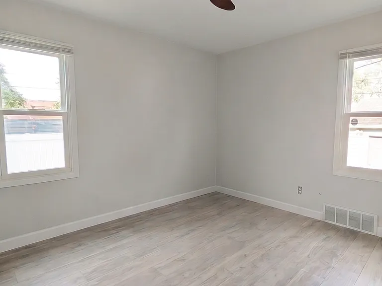 Bedroom #1 with ceiling fan, lots of natural daylight, and nice size closet
