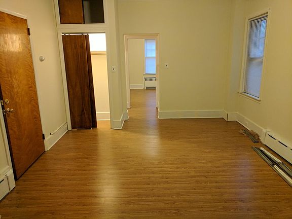 living room with coat closet (bedroom seen through doorway)