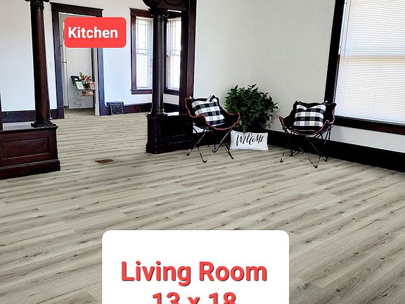Standing in the foyer looking through the front room to the dining room and the kitchen is beyond. New LVP flooring throughout the house August 2026.