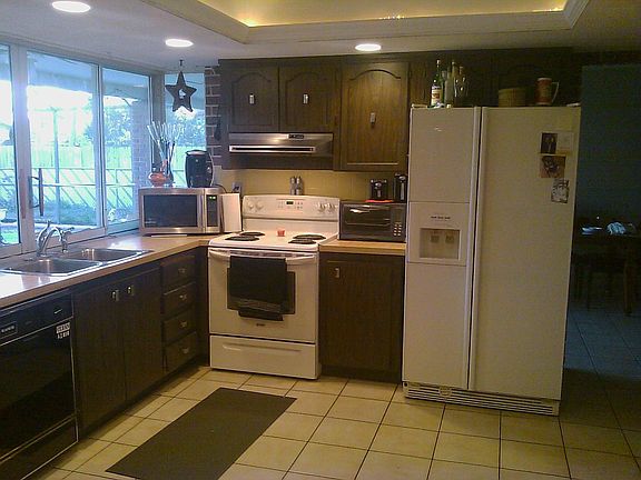 kitchen with slilders overlooking screened pool area