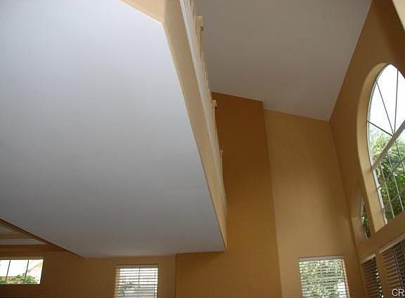 Soaring, dramatic two story ceiling over living room floods the