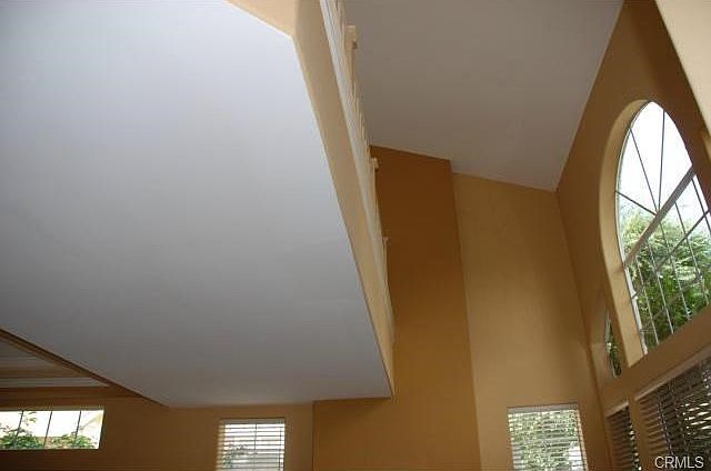 Soaring, dramatic two story ceiling over living room floods the