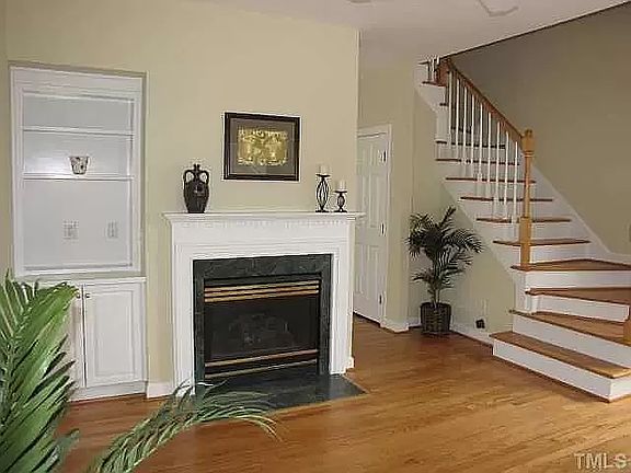 Another view of the family room highlighting the built in shelves and fireplace.