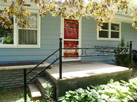 Here's a View of the Front Brick Porch...The Home has Real Red Wood siding
