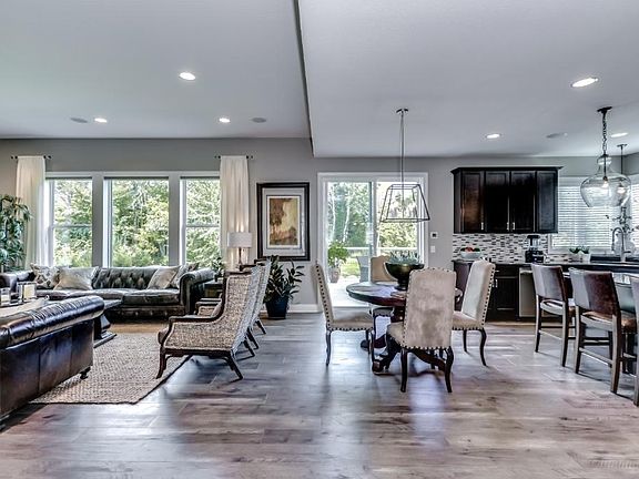 View walking towards the back of the home.  Hardwood floors throughout.  Open style concept with eat in kitchen.