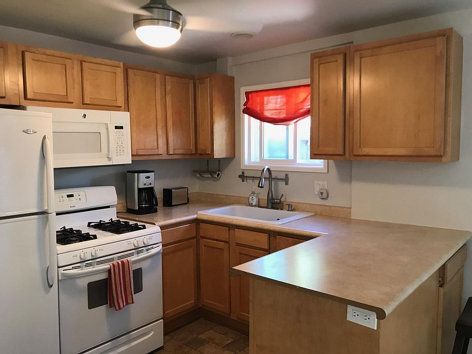 Kitchen with fridge, stove with microwave. and breakfast bar