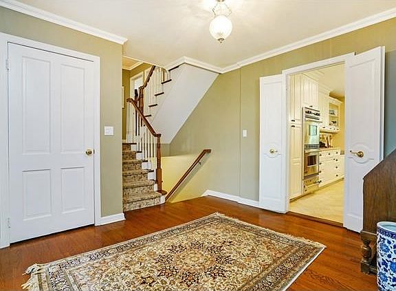 Gracious entrance with lustrous hardwood flooring seen throughout the first floor.