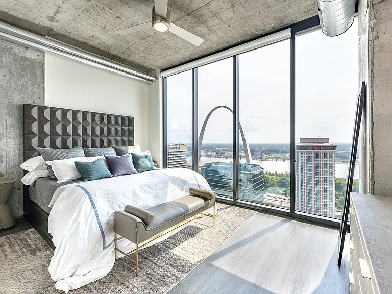 Cozy bedrooms with views of the St. Louis Arch at One Cardinal Way Luxury Apartments
