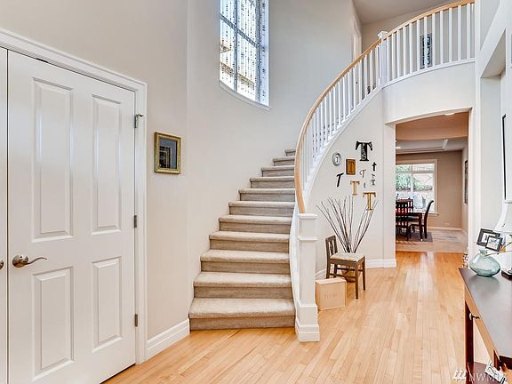 Grand Entry with Sophisticated, Curved Staircase and Gorgeous Hardwood Floors