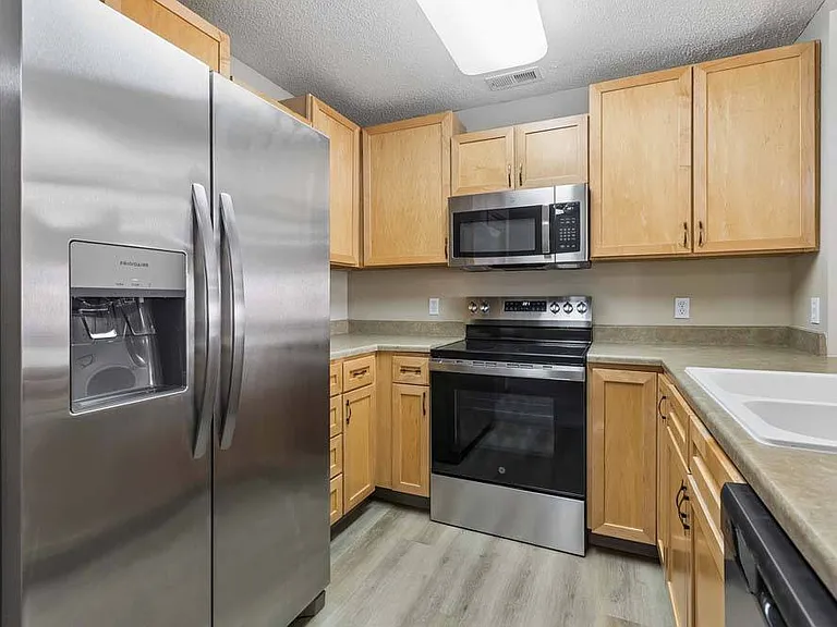 Thoughtfully designed with stainless steel appliances and warm cabinetry, this kitchen makes every meal feel inviting.