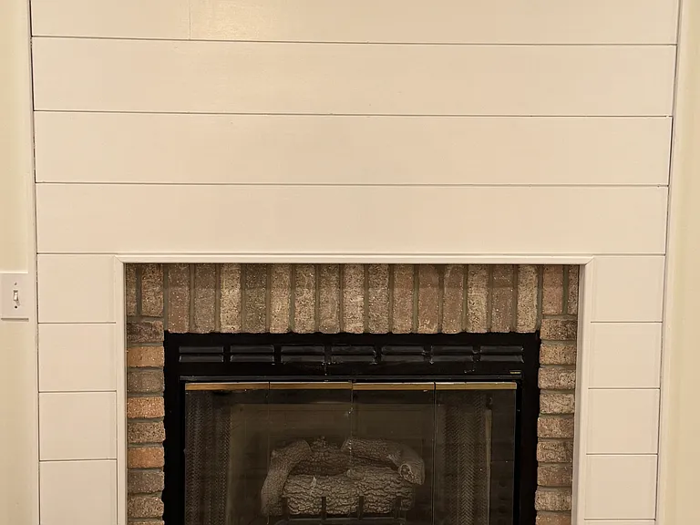 Fireplace with gas logs and wider for TV.