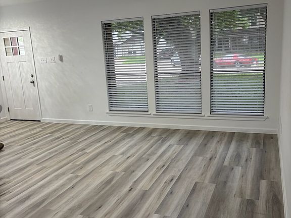 Living room. New flooring, lights, fan, blinds