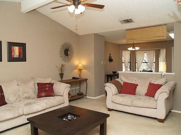 Living room with fireplace and vaulted ceilings