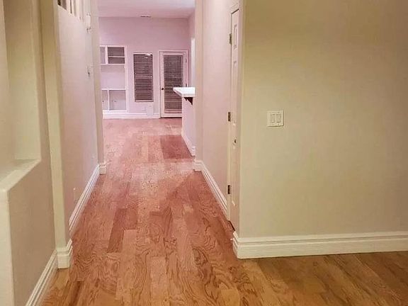 Picture taken from front door, two bedrooms to the left, living room type area to the right, kitchen down the hall to the right and primary bedroom in back of house to right down the hall