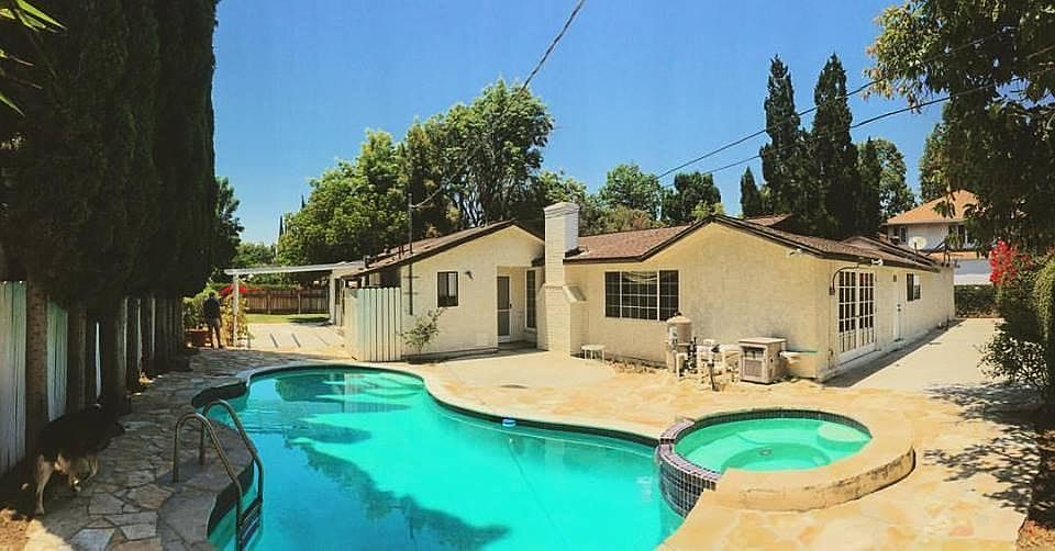 swimming pool and jacuzzi and concrete backyard