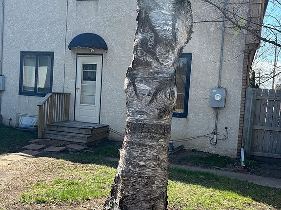 Side entrance from adjacent garage spot and parking.
