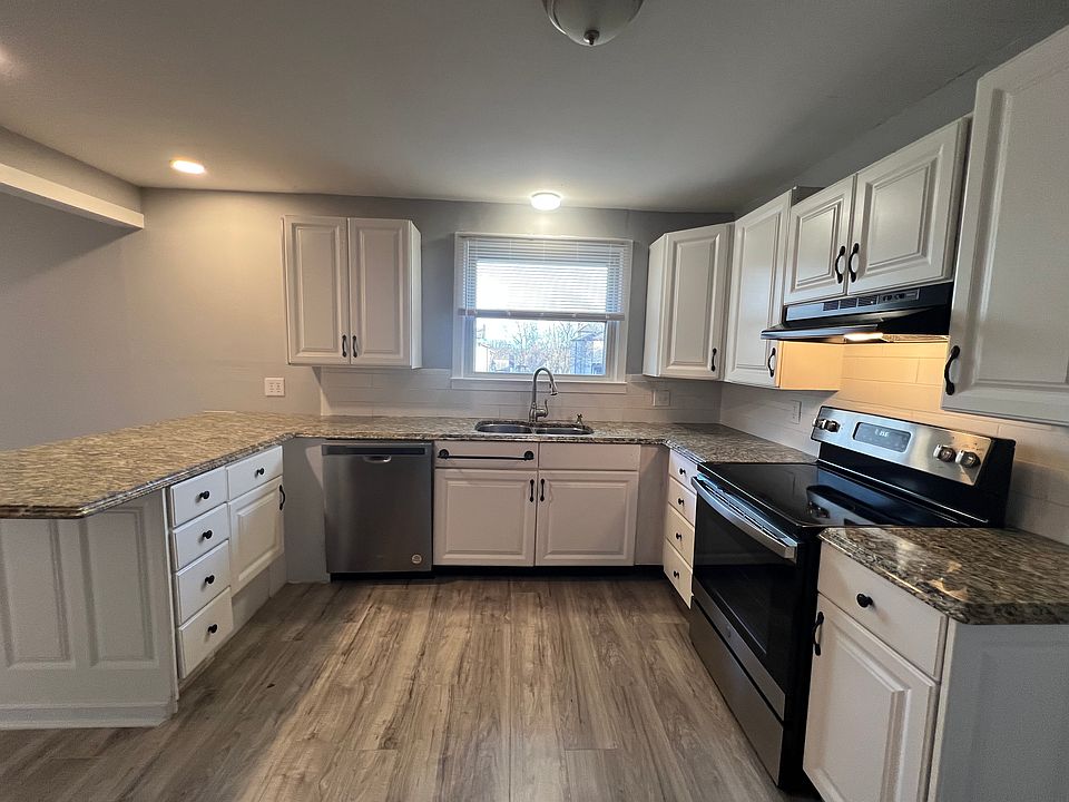 Kitchen with all new appliances and granite counter tops. Room pantry next to refrigerator.