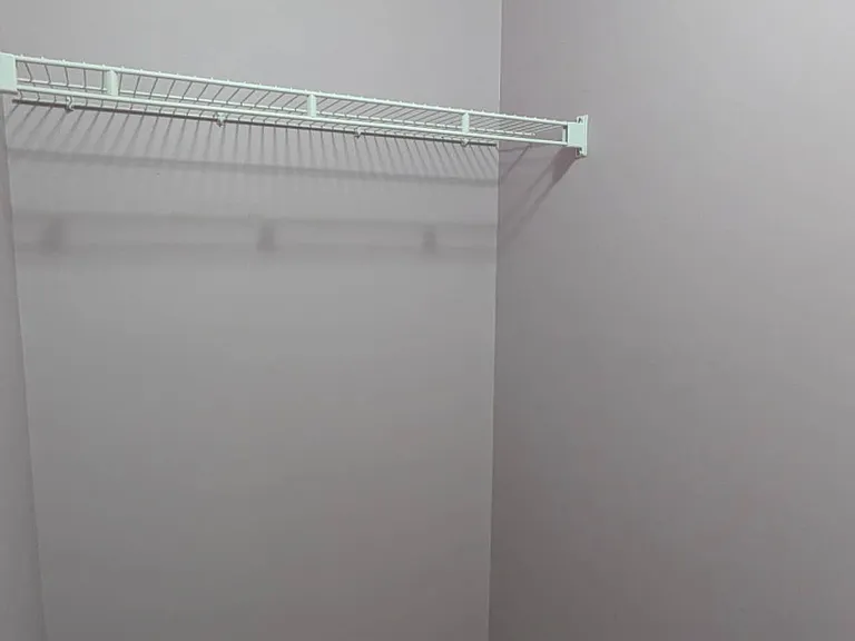 A separate walk-in closet connecting Bedroom 1 and the bathroom.