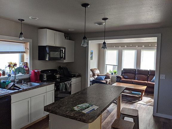 View from back hallway into kitchen and living room