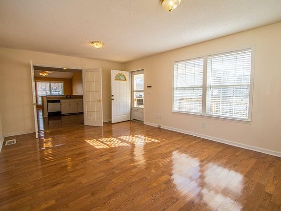 view from rear den looking at french door thru kitchen to front of house. Hardwood floors in all common areas