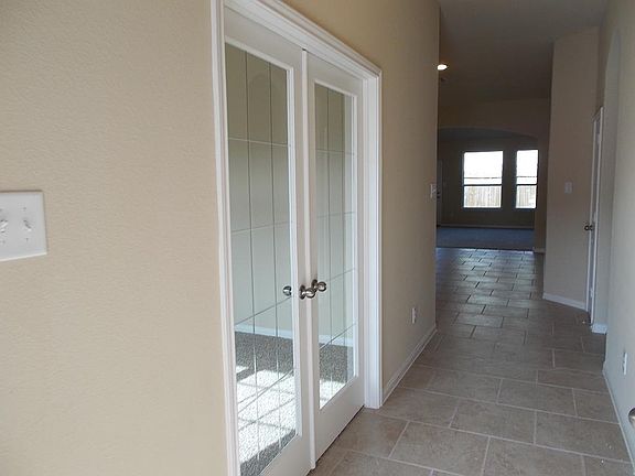 As you enter your new home you will have this amazing view with the study to your left with double French doors tile flooring and peek of your family room,