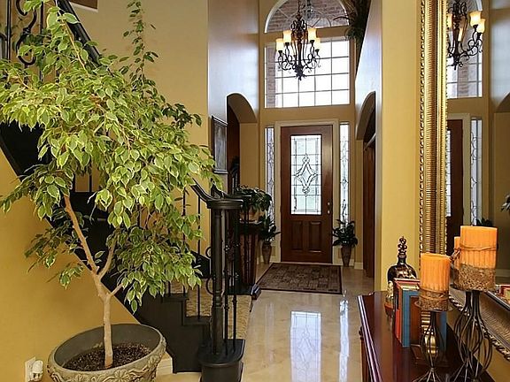 Entry hall with lead glass doors and travertine floors