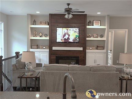 Custom designed fireplace and built in shelving with TV