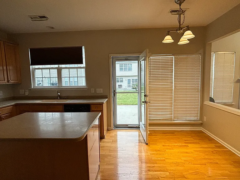 Another view from kitchen looking into back yard straight ahead and living room to the right.